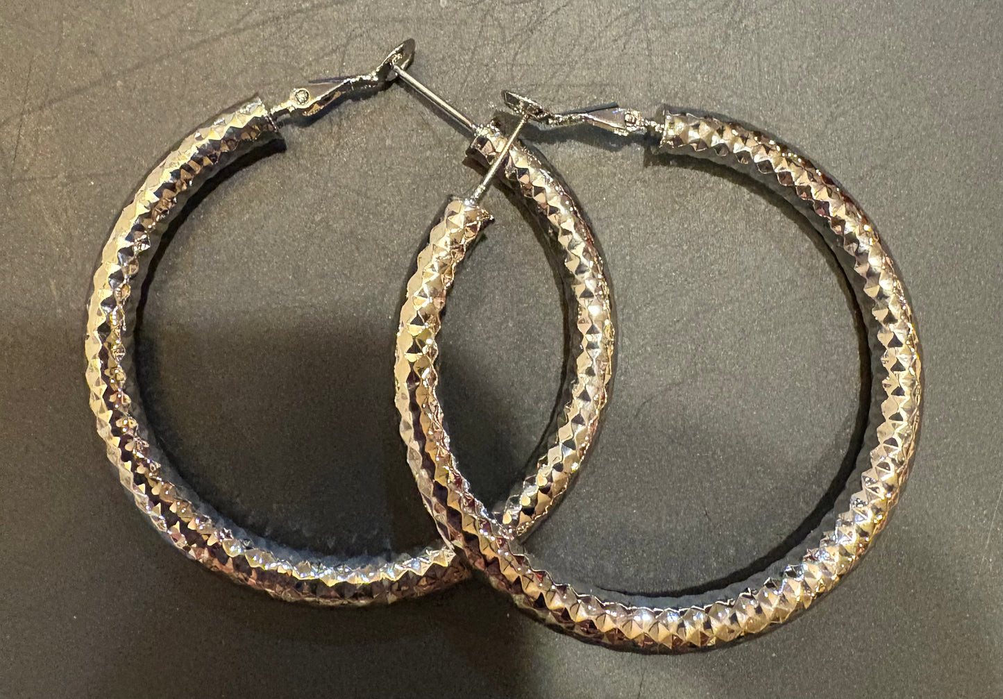 Silver large shiny hammered loop earrings
