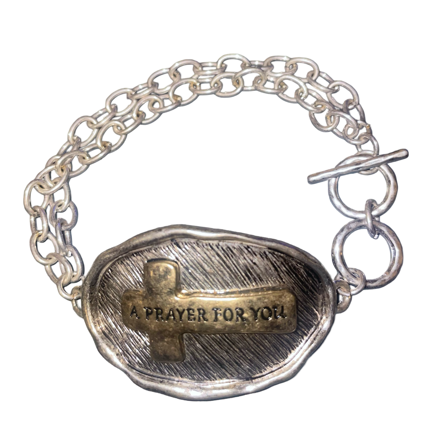 Silver tone toggle bracelet stamped with "A Prayer For You " on a gold tone cross on the front, and a prayer stamped on the back.