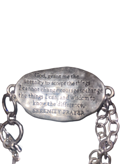 Silver tone toggle bracelet stamped with "Serenity Prayer " on a gold tone cross on the front, and the serenity prayer stamped on the back