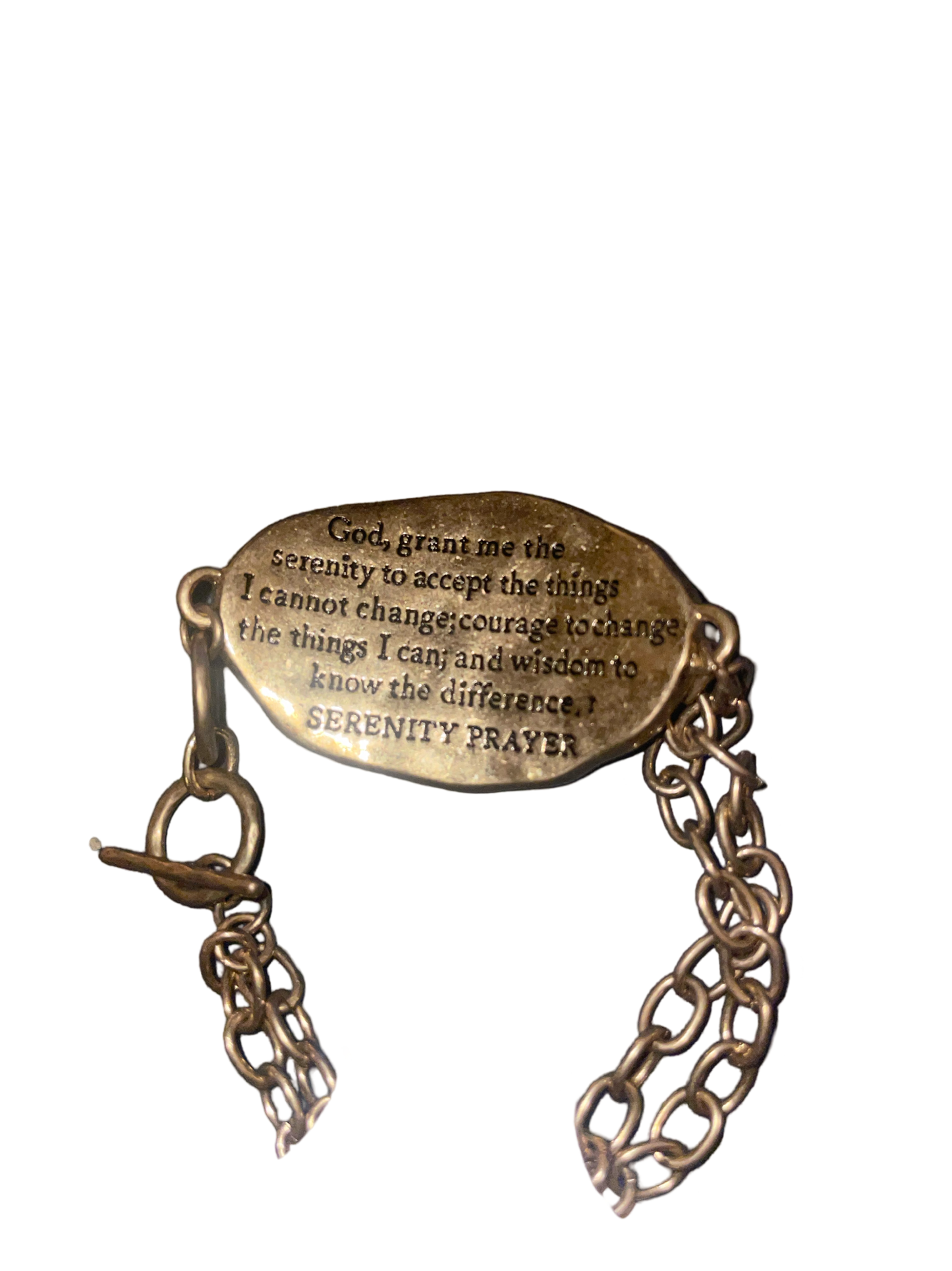 Gold tone toggle bracelet stamped with "Serenity Prayer " on a silver tone cross on the front, and the serenity prayer stamped on the back