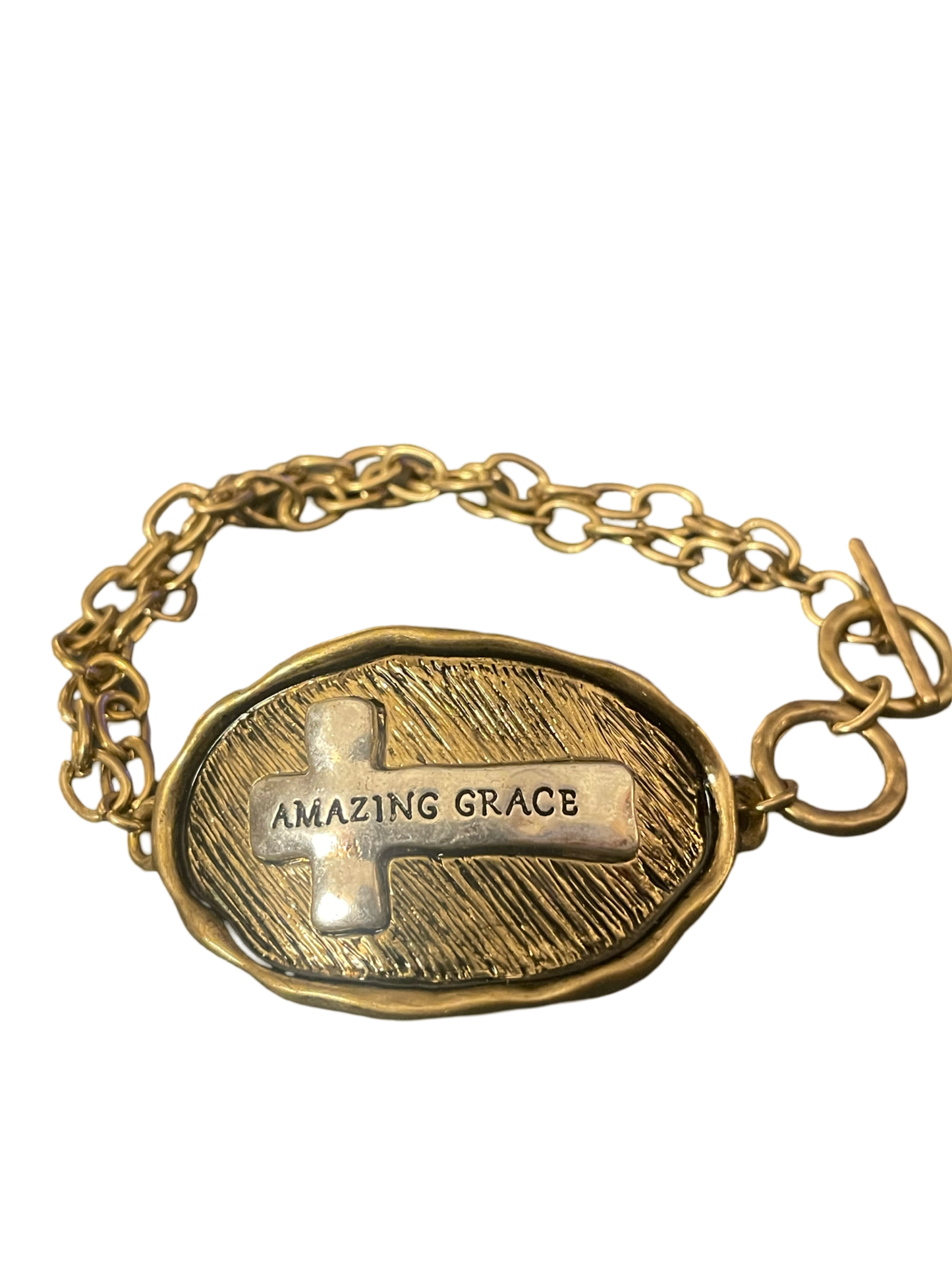 Gold tone toggle bracelet stamped with "Amazing Grace " on a silver tone cross on the front, and the words to Amazing Grace stamped on the back