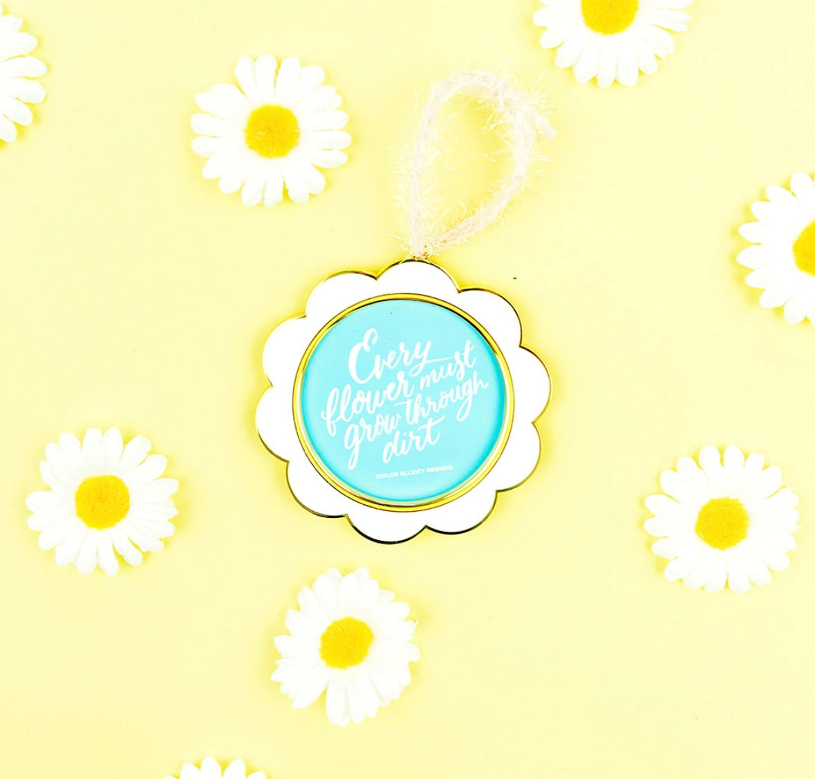 Ornament / Frame - Flower shaped frame with quote “Every flower must grow through dirt”. Quote can be removed to add your own picture. 3 1/2” diameter.