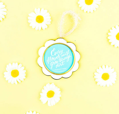 Ornament / Frame - Flower shaped frame with quote “Every flower must grow through dirt”. Quote can be removed to add your own picture. 3 1/2” diameter.
