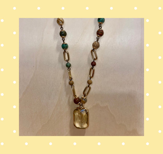 Long necklace with beads, chain link and faceted pendant