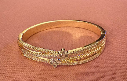 Bracelet - Twisted and layered clover CZ and gold hinged push button lock bangle