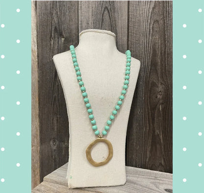 Long wooden mint turquoise beads with mini gold beads and hammered metal pendant